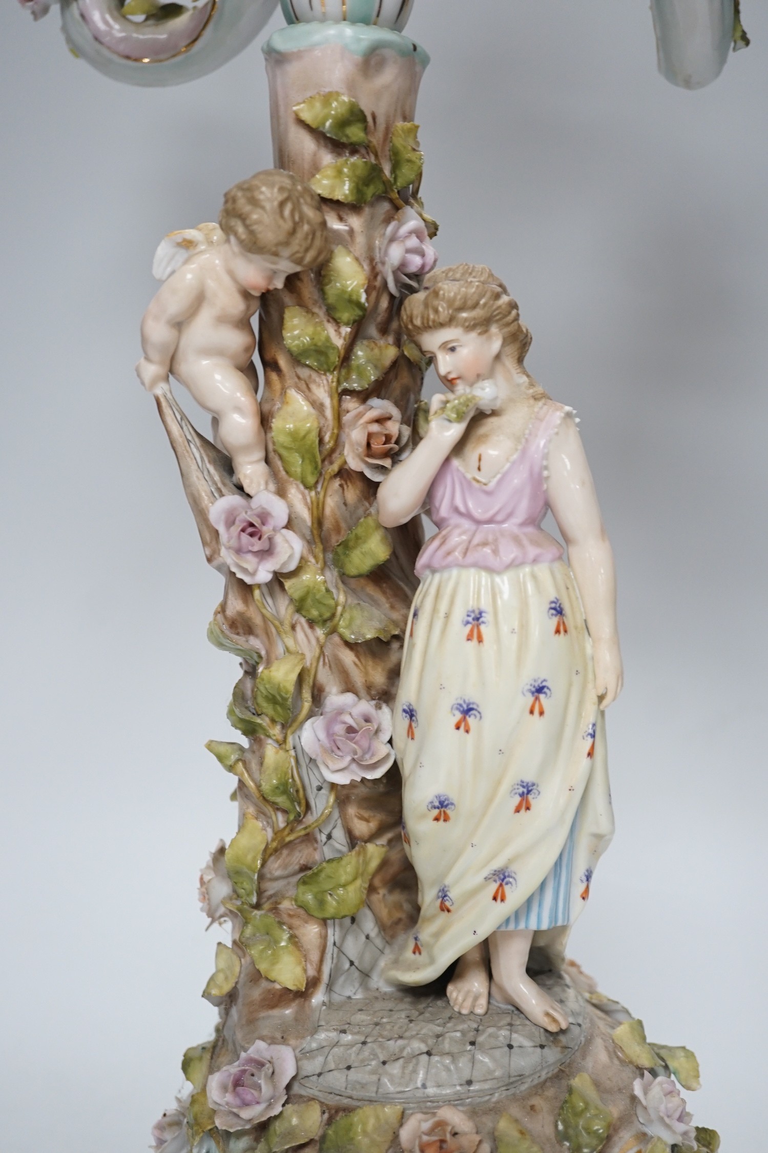 A Sitzendorf-style floral encrusted 4 branch candelabra, 57cms high